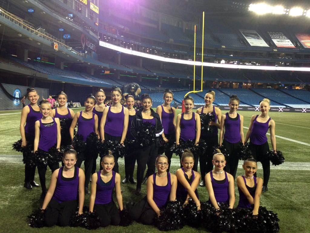 Purple Thunder competitive dance team performing at the Argos game