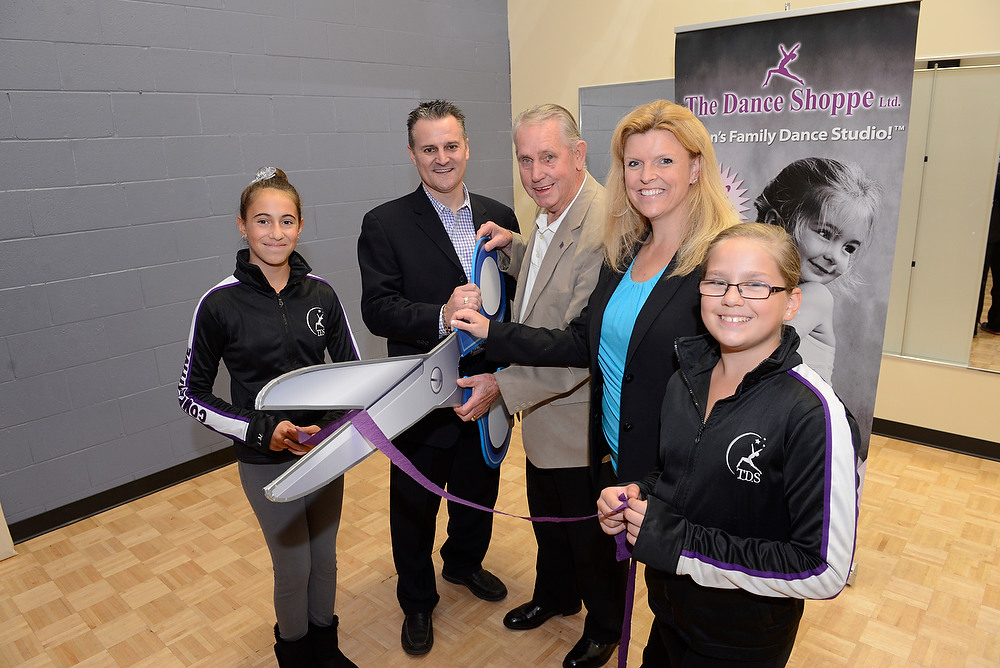 Milton dance studio owner and director along with 2 dance students and Milton mayor Krantz cutting the ribbon at the grand re-opening