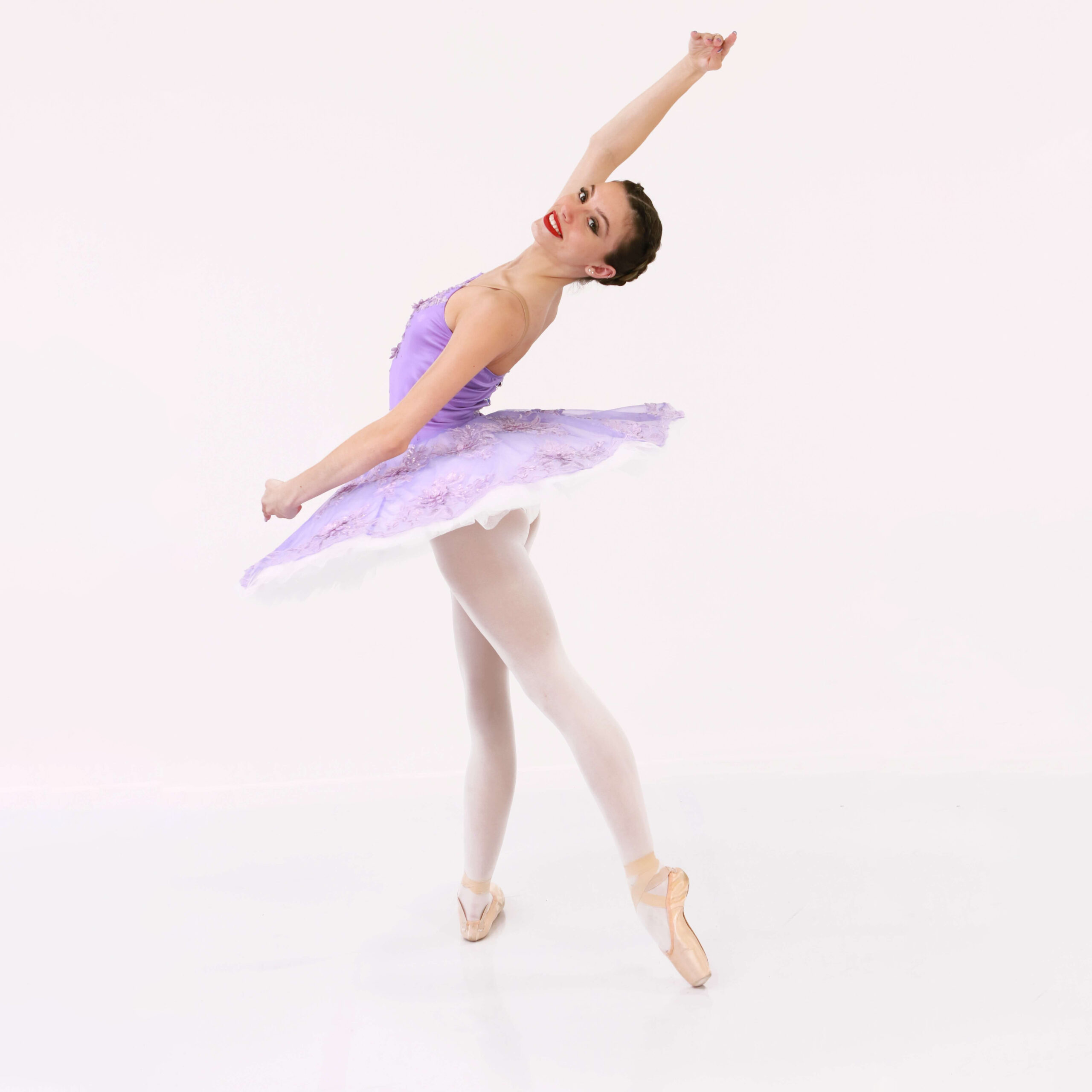 RAD ballet dancer from The Dance Shoppe in Milton in a ballet pose wearing a purple ballet costume