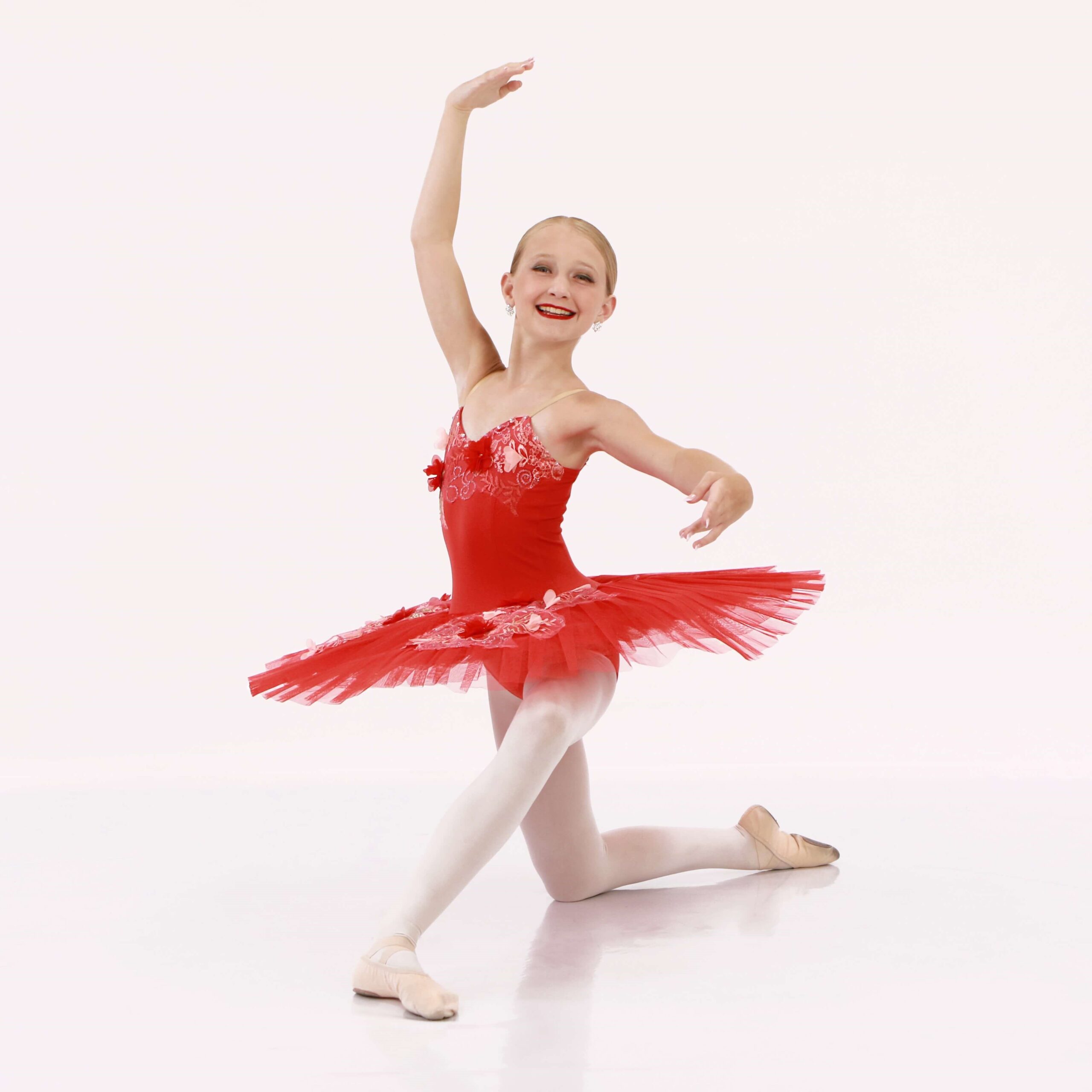 10 year old ballet class dancer from Milton wearing a red tutu in a ballet pose