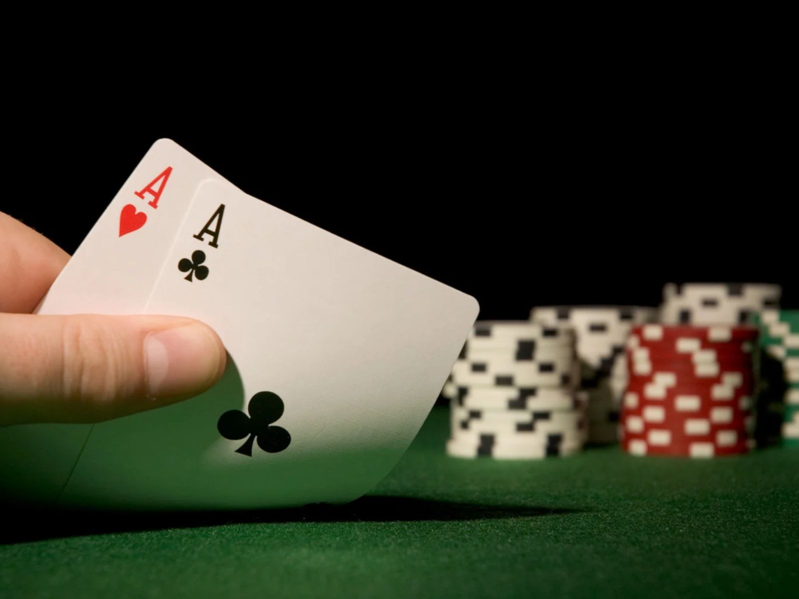 poker table with hand showing two aces
